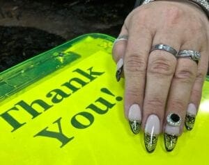 A woman 's hand with rings on her fingers.