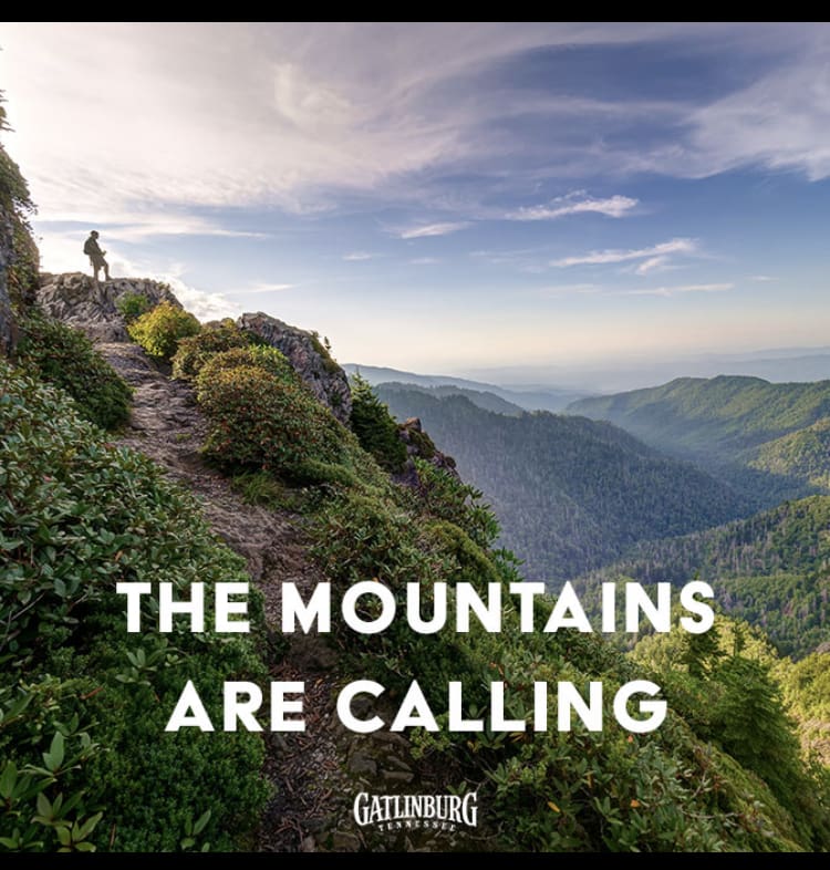 A hiker on top of an overlook where they can see for miles over the Great Smoky Mountains National Park.