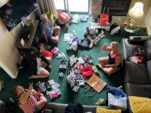 A group of people sitting around on the floor