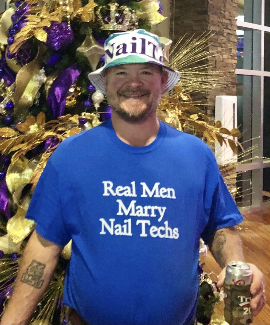 A man wearing a blue shirt and hat.