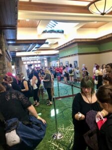 A crowd of people standing around in an indoor area.