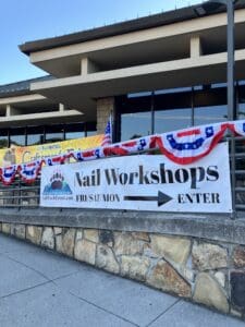 A sign that says nail workshops and directions.