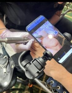 A person holding a phone and taking a picture of something