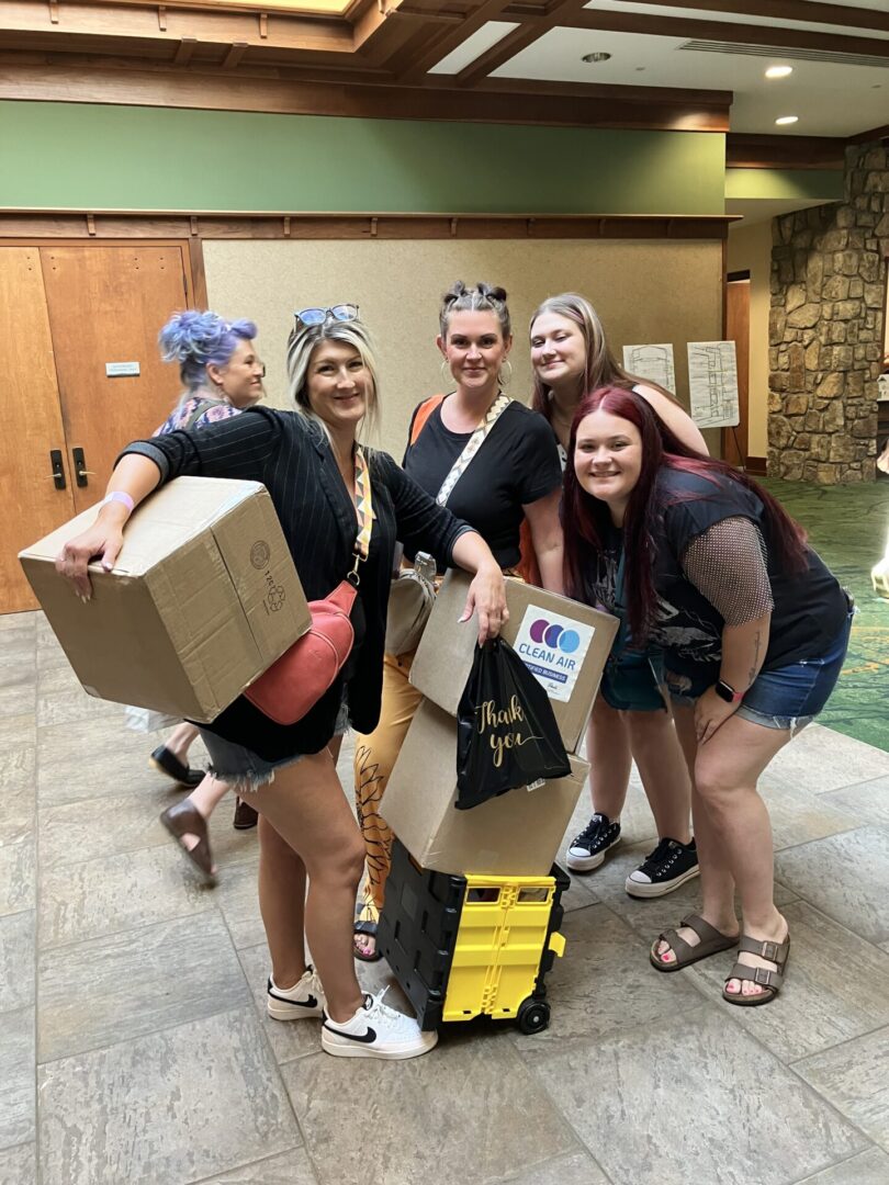 Nail techs holding their big purchases at the Smokies Nail Show.