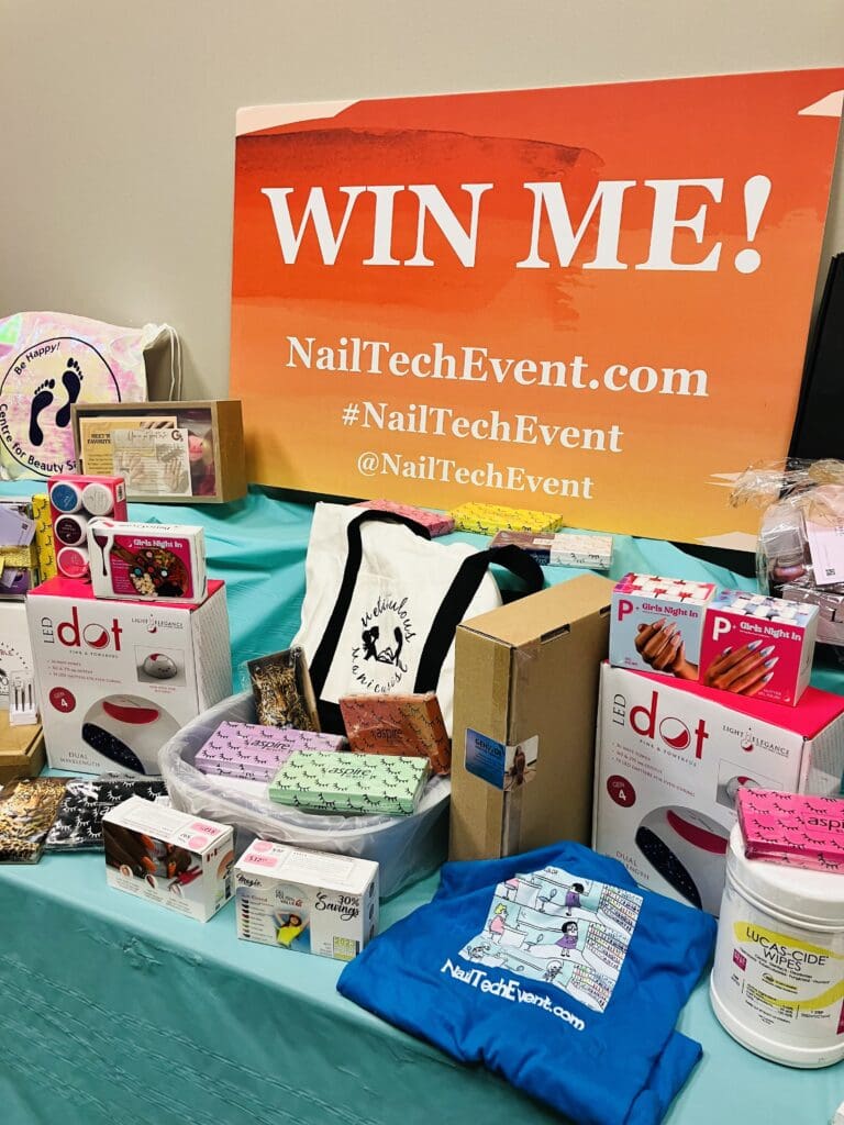 orange sign with "win me" printed on it sitting on a table with lots of nail products