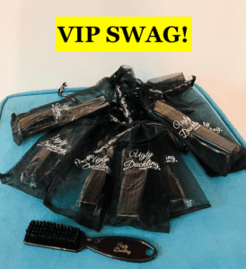 Small black organza bags monogrammed with Ugly Duckling & 1 black nylon nail scrub brush inside.