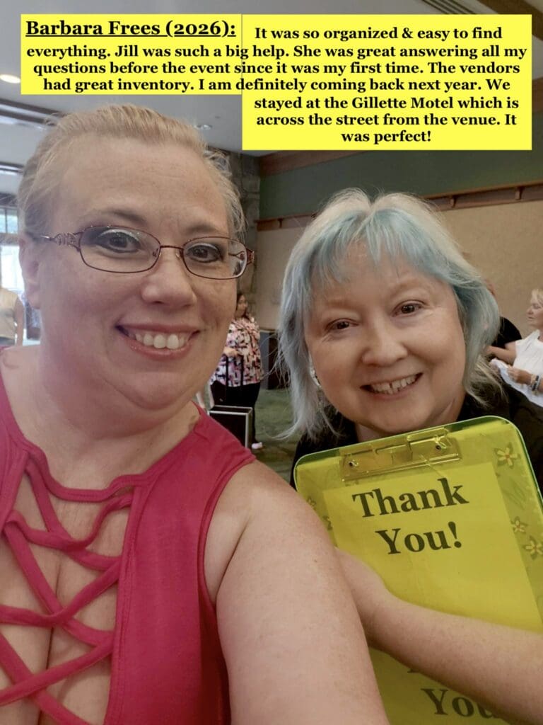 2 women smiling at the camera with 1 holding a clipboard that reads "thank you"